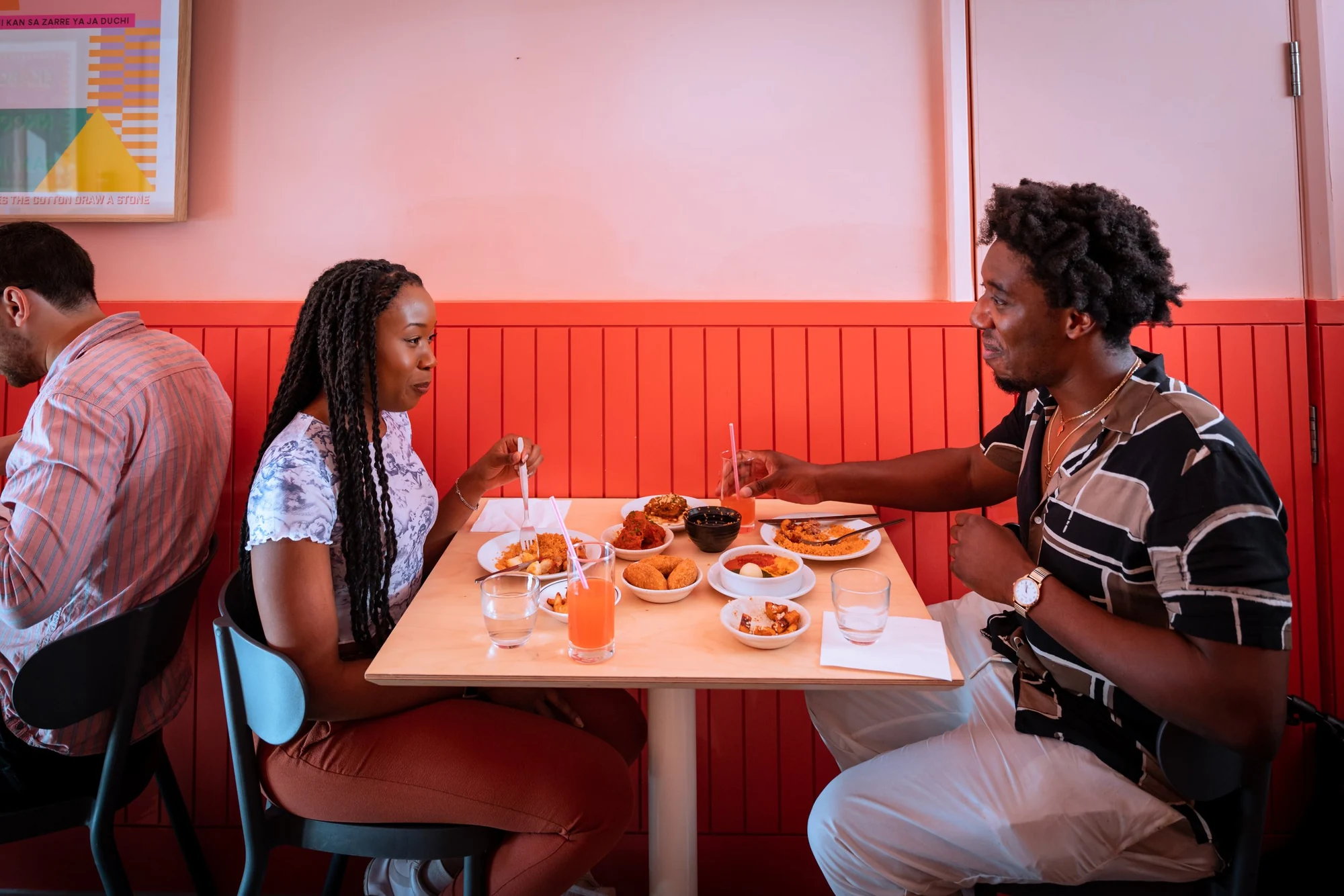 Two guests catching up over sharing plates at Chuku’s