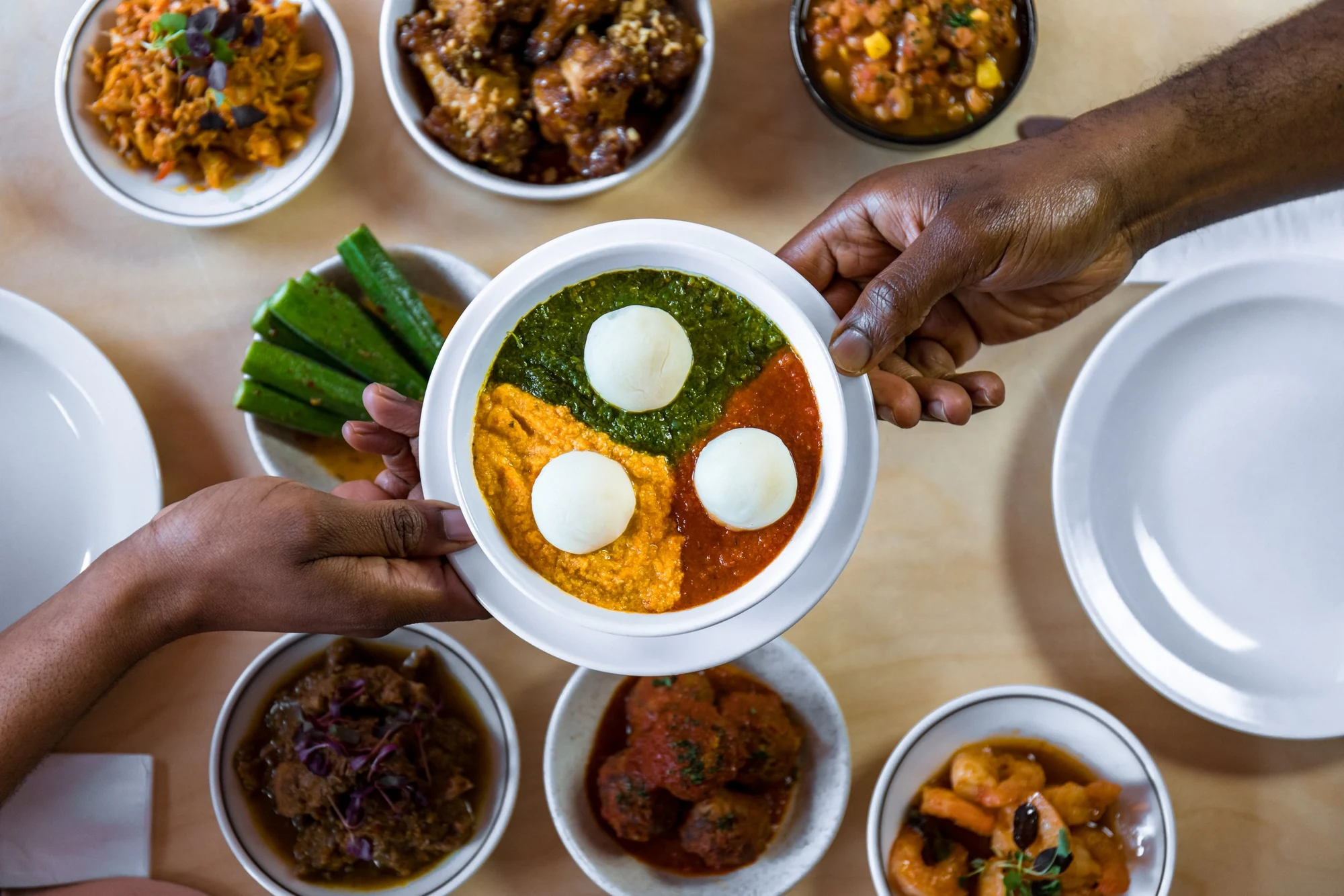 Egusi bowl and a table of Chuku’s sharing plates