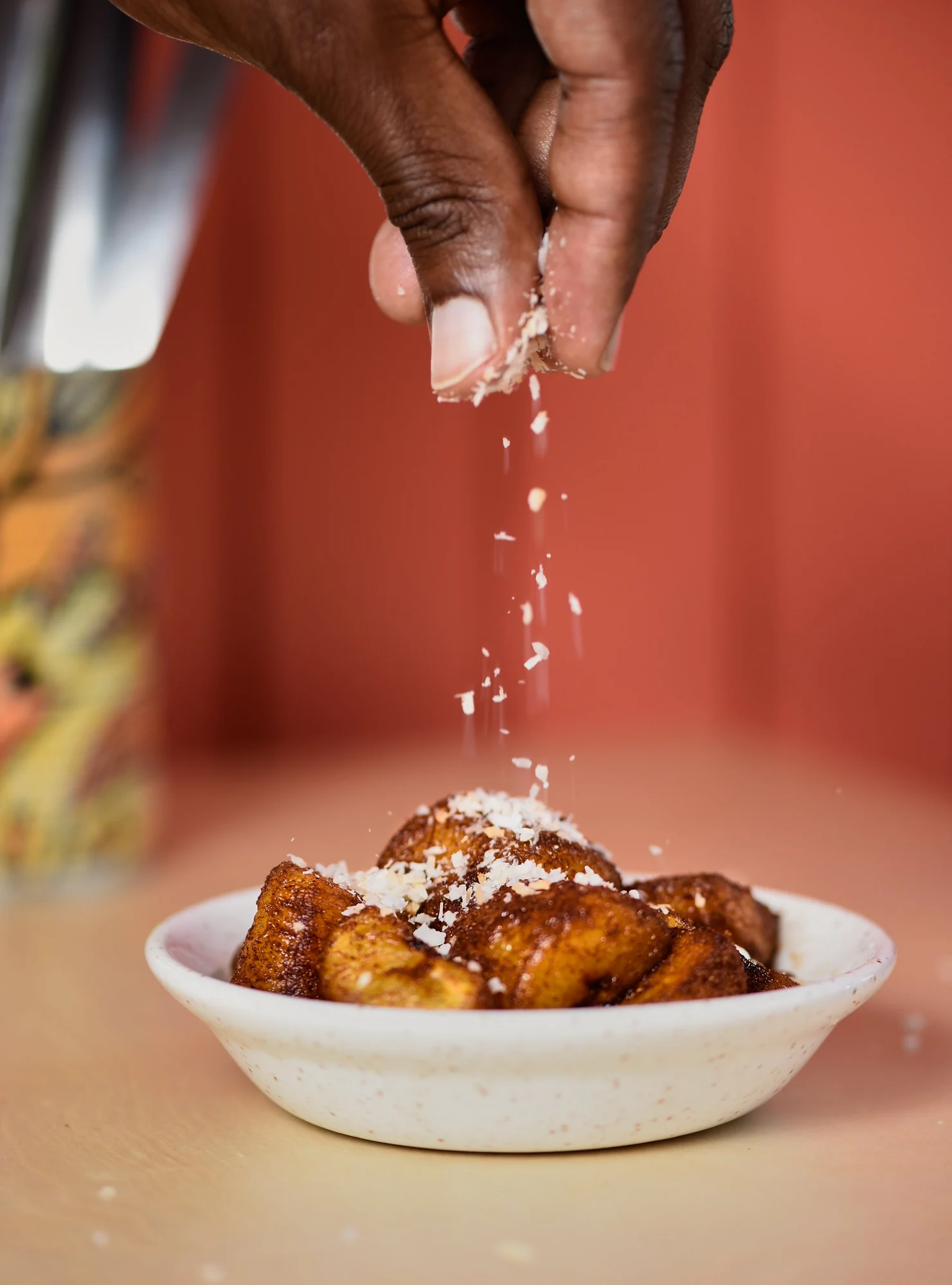 A finishing touch being sprinkled over a dish at Chuku’s