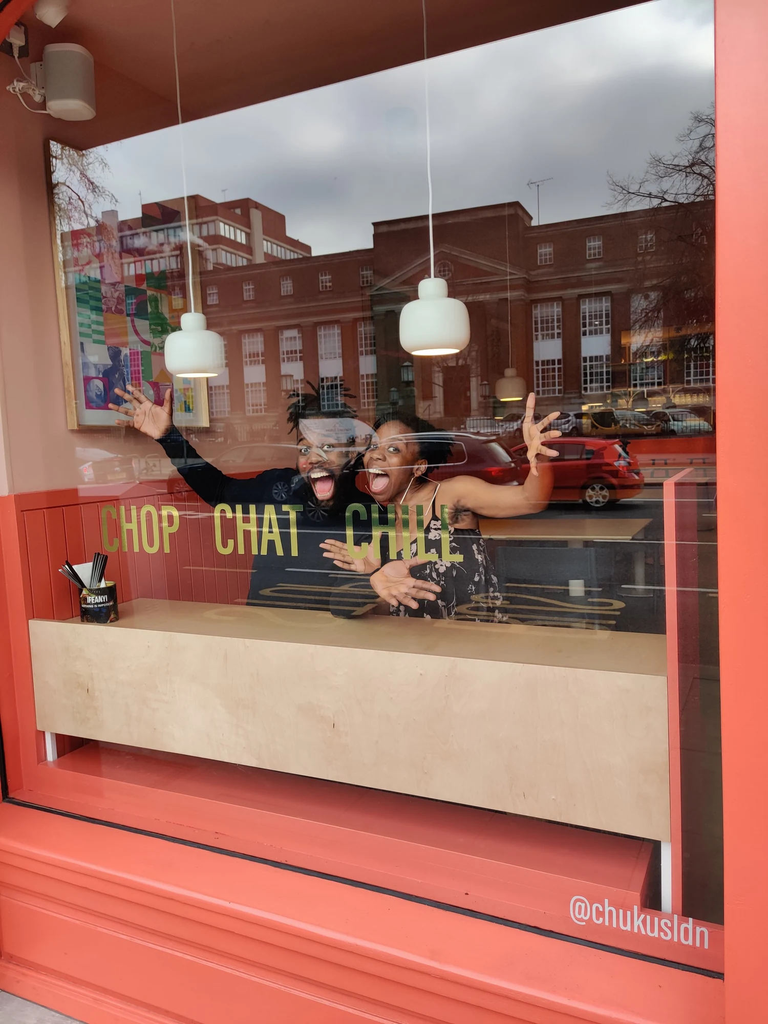 Brother-and-sister founders Emeka and Ifeyinwa Frederick in Chuku’s restaurant window