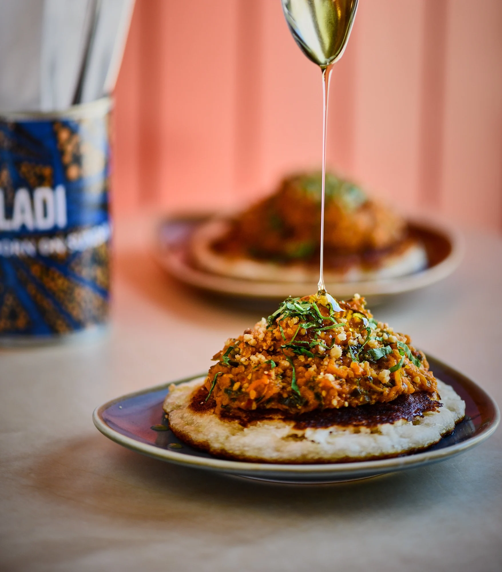 Sinasir at Chuku’s, with sauce being poured over the dish
