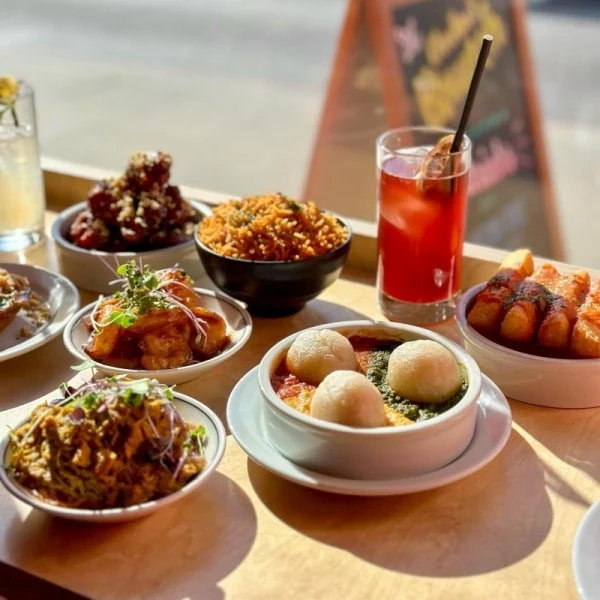 A table full of Chuku’s food and drinks by the restaurant window